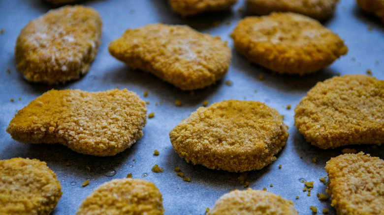 Frozen chicken nuggets on a sheet tray