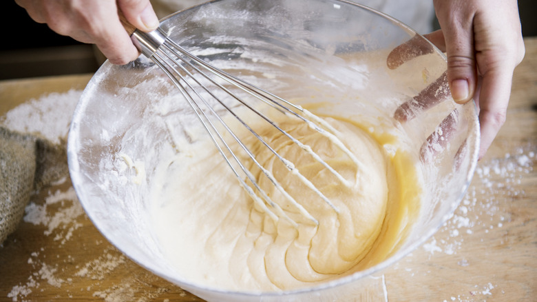 person whisking cake batter
