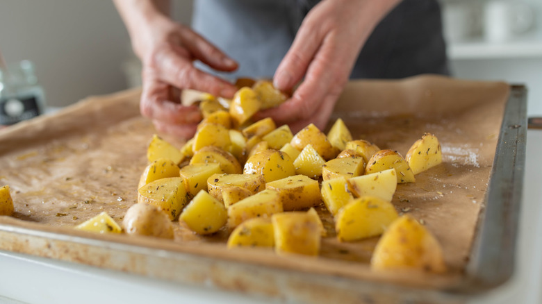 woman preparing potatoes in a pan