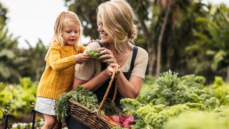 Mother and daughter picking out produce