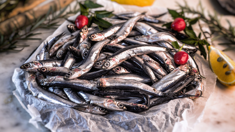 A pile of fresh anchovies on a plate