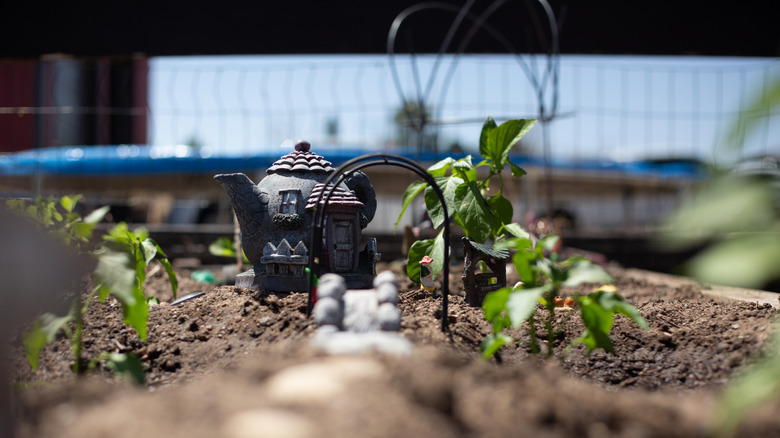 A clay teapot in a sunlit garden
