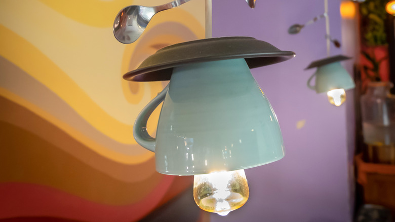 A tea cup light fixture hanging from the ceiling