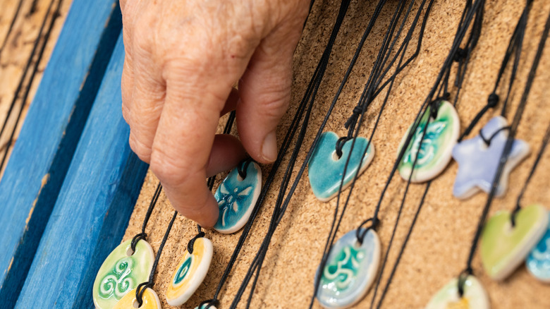 A man selecting a piece of handcrafted artisan jewelry