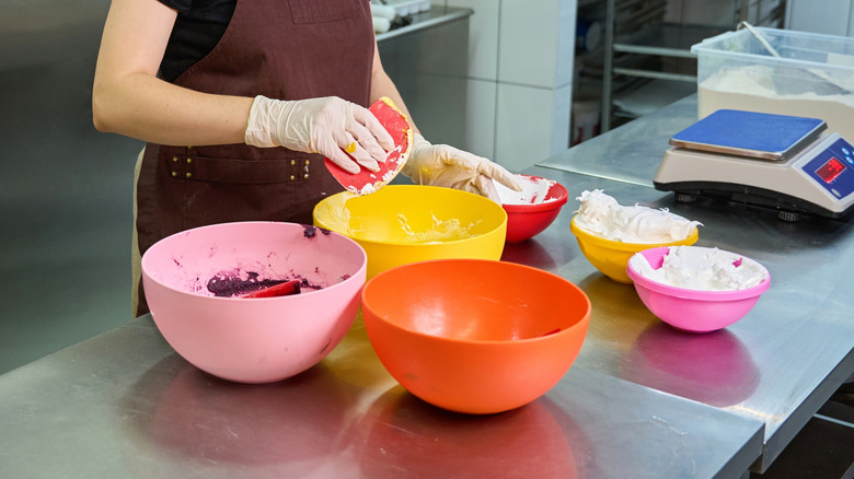 Chef using a bowl scraper for macronage