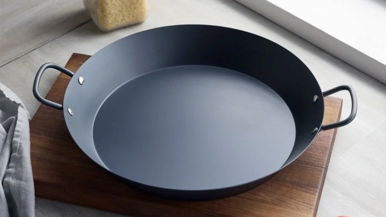 The GreenPan 15-inch paella pan sold at Costco sitting on a butcher block.