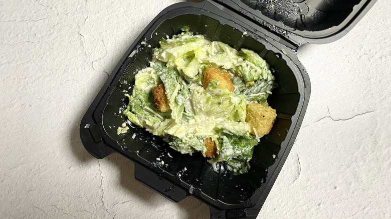 Dave & Buster's Caesar Salad in a small takeout container