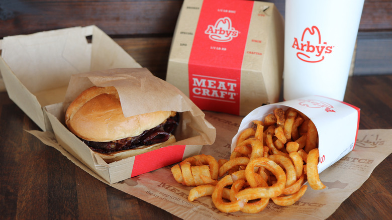A burger, drink, and curly fries from Arby's
