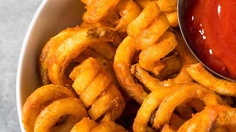 A close-up of Curly Fries with ketchup from Arby's