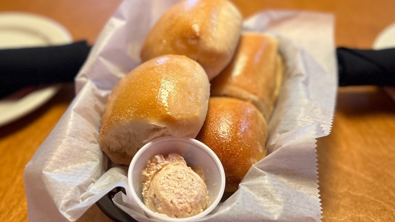 A basket of rolls with honey cinnamon butter at Texas Roadhouse