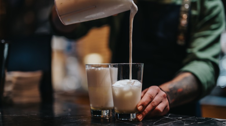 Bartender preparing a white cocktail