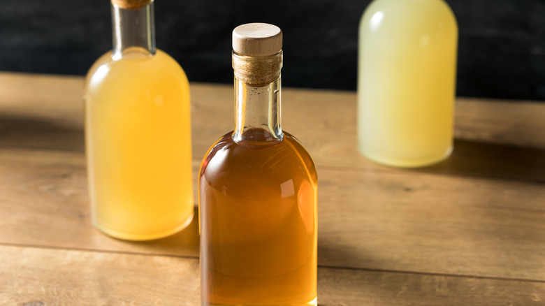 Glass bottles of brown, orange and yellow liquid