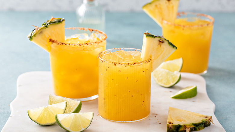 Pineapple margaritas with chili rim and fresh pineapple garnishes
