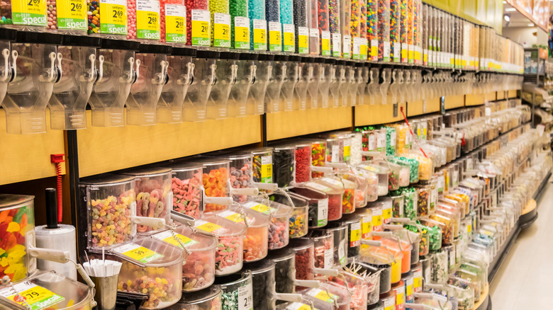Grocery store aisle of bulk-sized candy dispensers