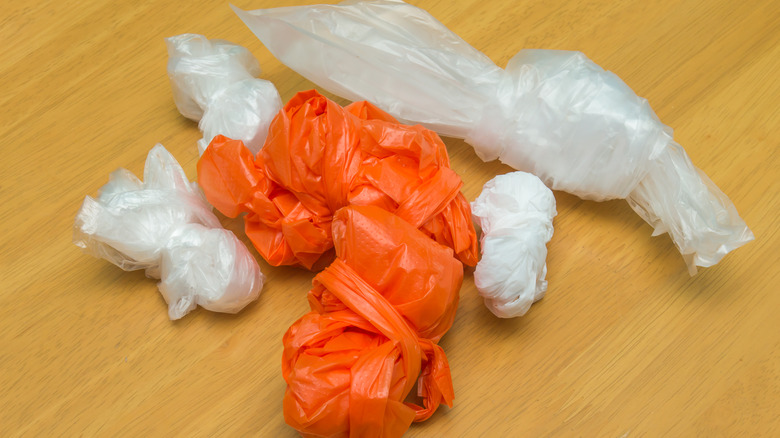 Various disposable plastic bags balled up on a wooden counter top
