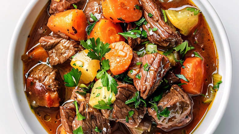 A close up of a bowl of beef and vegetable stew