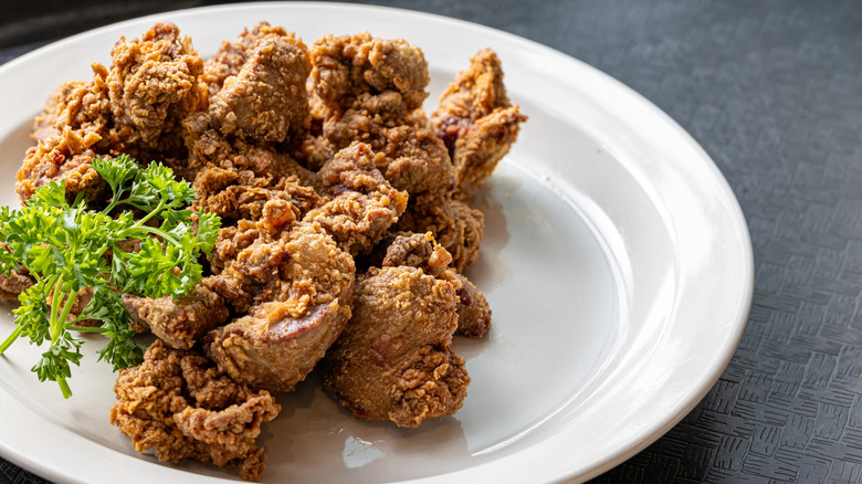 A close up of fried chicken livers on a white plate