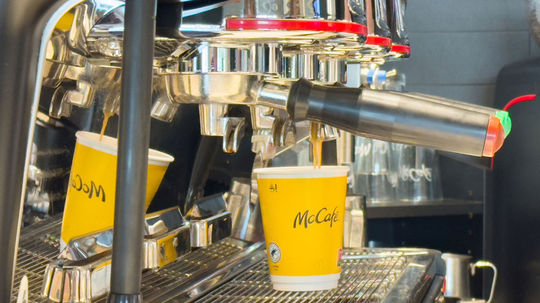 a McCafé drink being prepared under an espresso machine