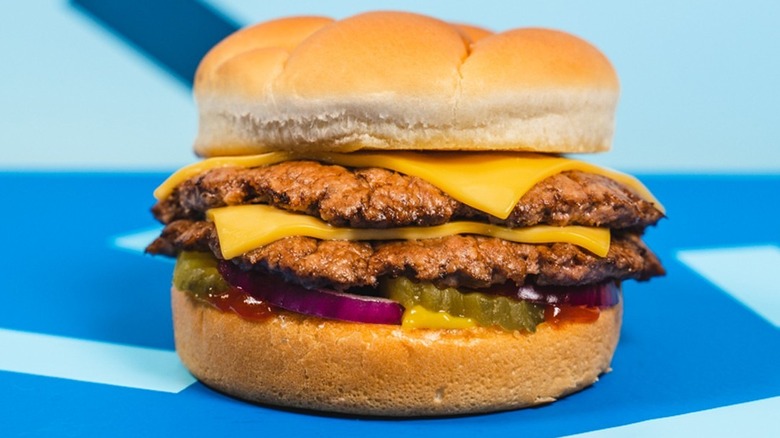 A Culver's cheeseburger on a blue table