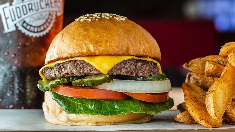A Fuddruckers burger with potato wedges