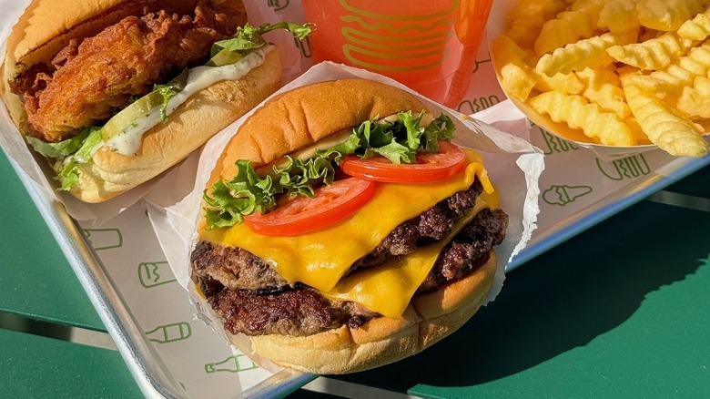 A Shake Shack burger, chicken sandwich, fries, and a drinks