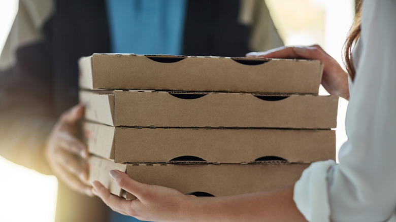 A person receiving pizza delivery order