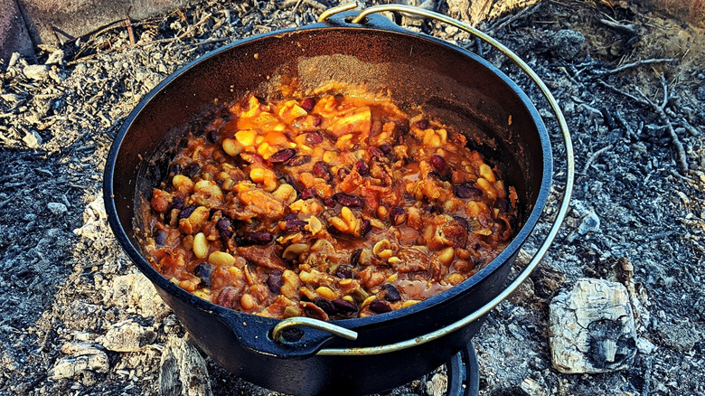 A pot of cowboy beans on a fire