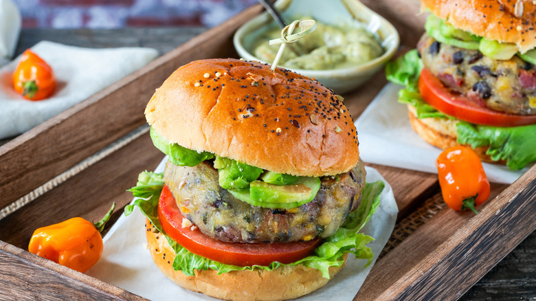 Black bean burger with avocado, spicy peppers, and veggies