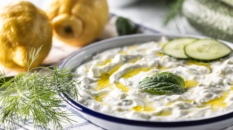 Dish of fresh tzatziki sauce with lemon, dill, and olive oil
