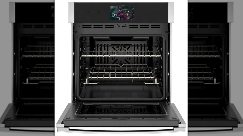 GE Profile 27" Smart Built-In Convection Single Wall Oven with an open door to show its spacious interior