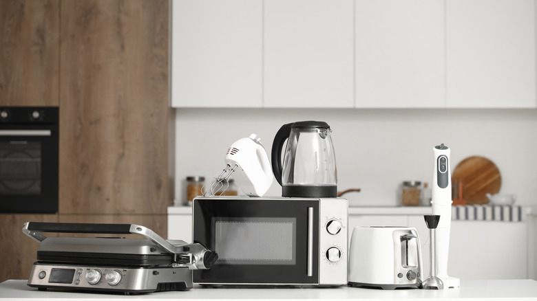 A variety of kitchen appliances sitting on a kitchen counter