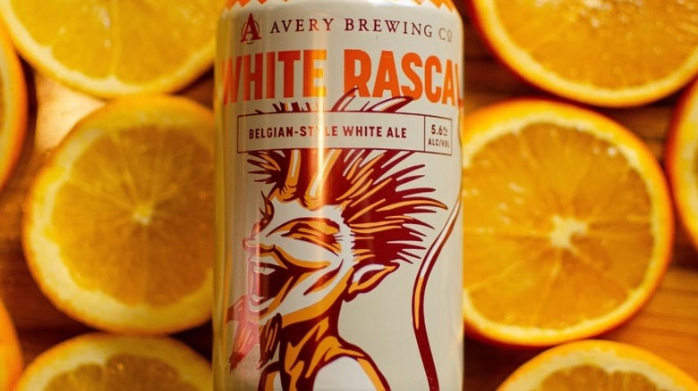 A can of Avery White Rascal Belgian-Style White Ale on a bed of orange wheels