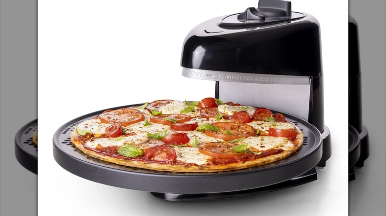 Countertop pizza maker on white background