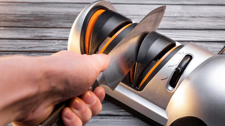 Knife being sharpened on an electric knife sharpener