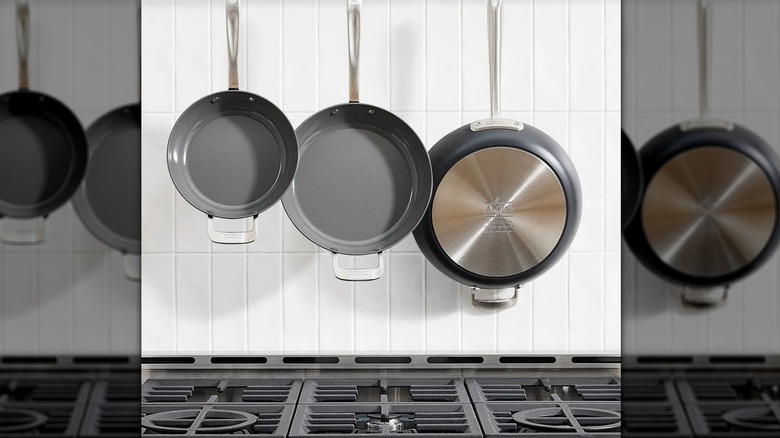 All-Clad frying pan set hanging over stove