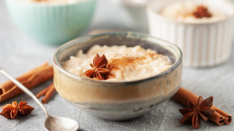 A bowl of arroz con leche with cinnamon and star anise