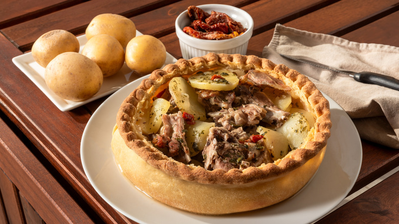 A Sardinian panada meat pie with lamb and potatoes