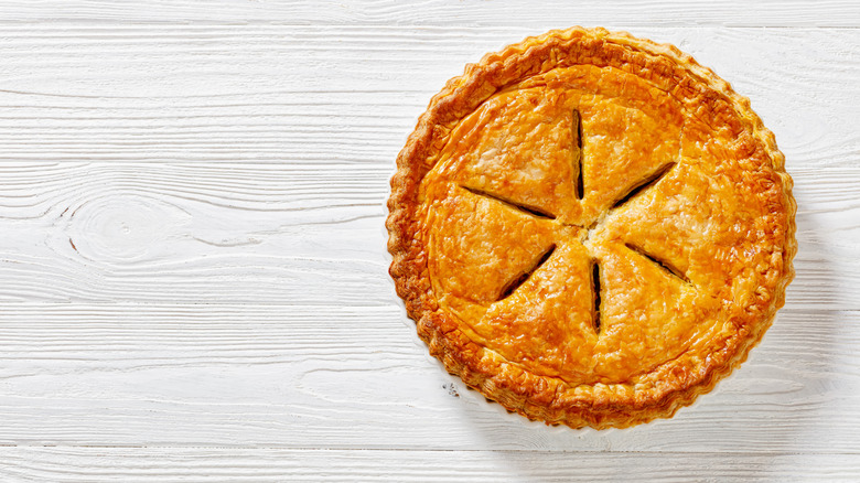 A pie with a vented lid on a table