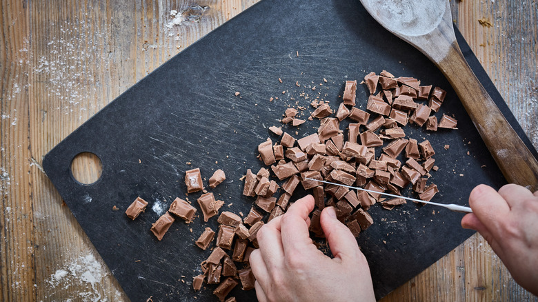 Hands chopping chocolate