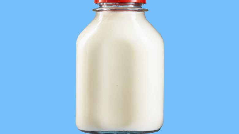 A milk bottle against a bright blue background