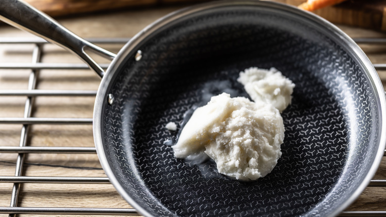 Pork lard melting in a frying pan