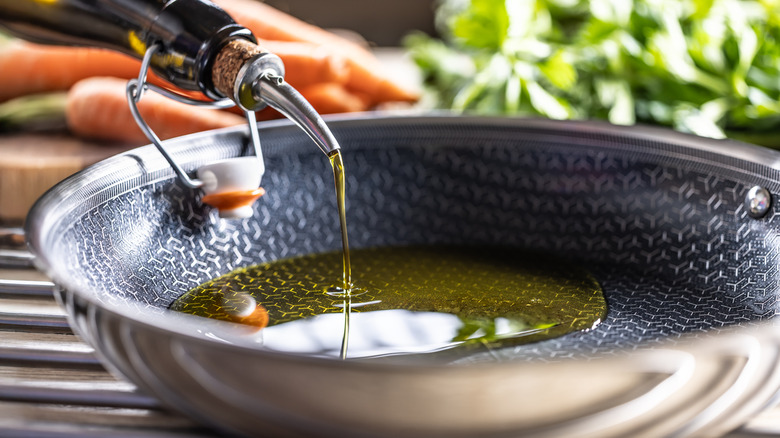 Oil being poured into a frying pan