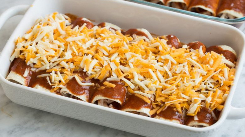 Enchiladas in a baking dish with cheese