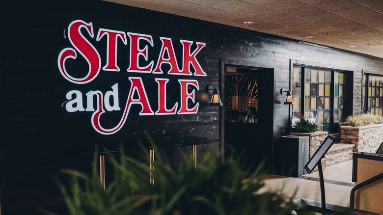 A plate of prime rib, lobster, and baked potato at Steak and Ale