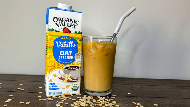Organic Valley non-dairy vanilla oat creamer next to a glass of iced coffee