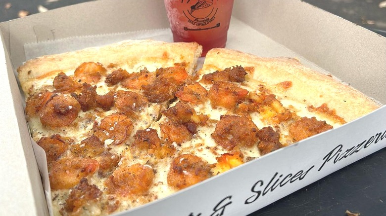 Pizza slices in box with drink