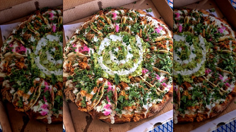 Taco pizza in cardboard box