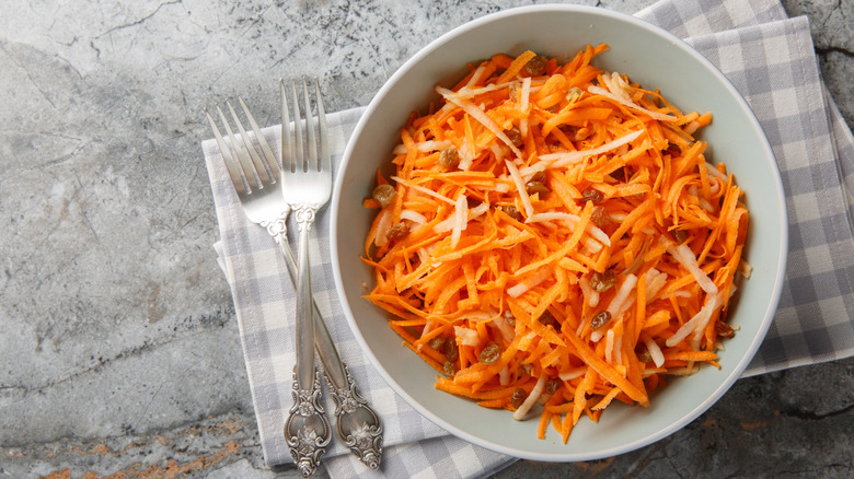 A bowl of carrot raisin salad on a table