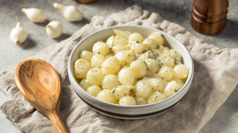 A bowl of creamed onions on a counter