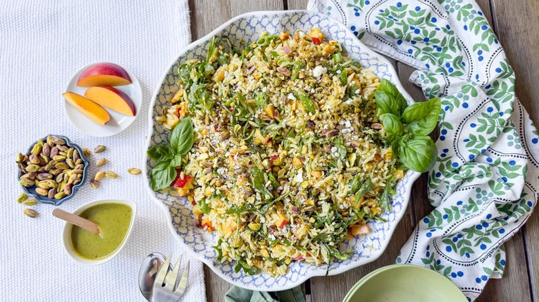 Large serving dish of Summery Grilled Corn and Orzo Salad with pistachios and a basil vinaigrette